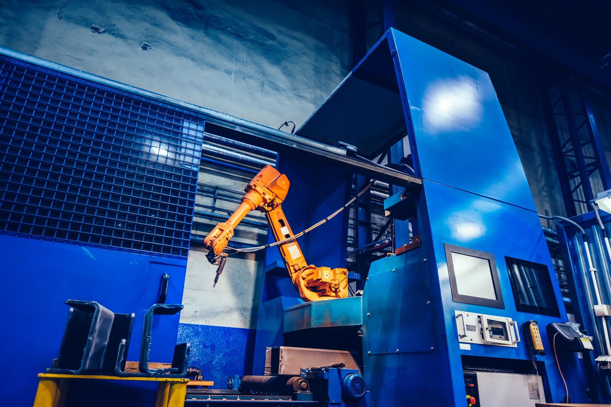Robotic arm in a factory. Modern heavy industry, machine learning