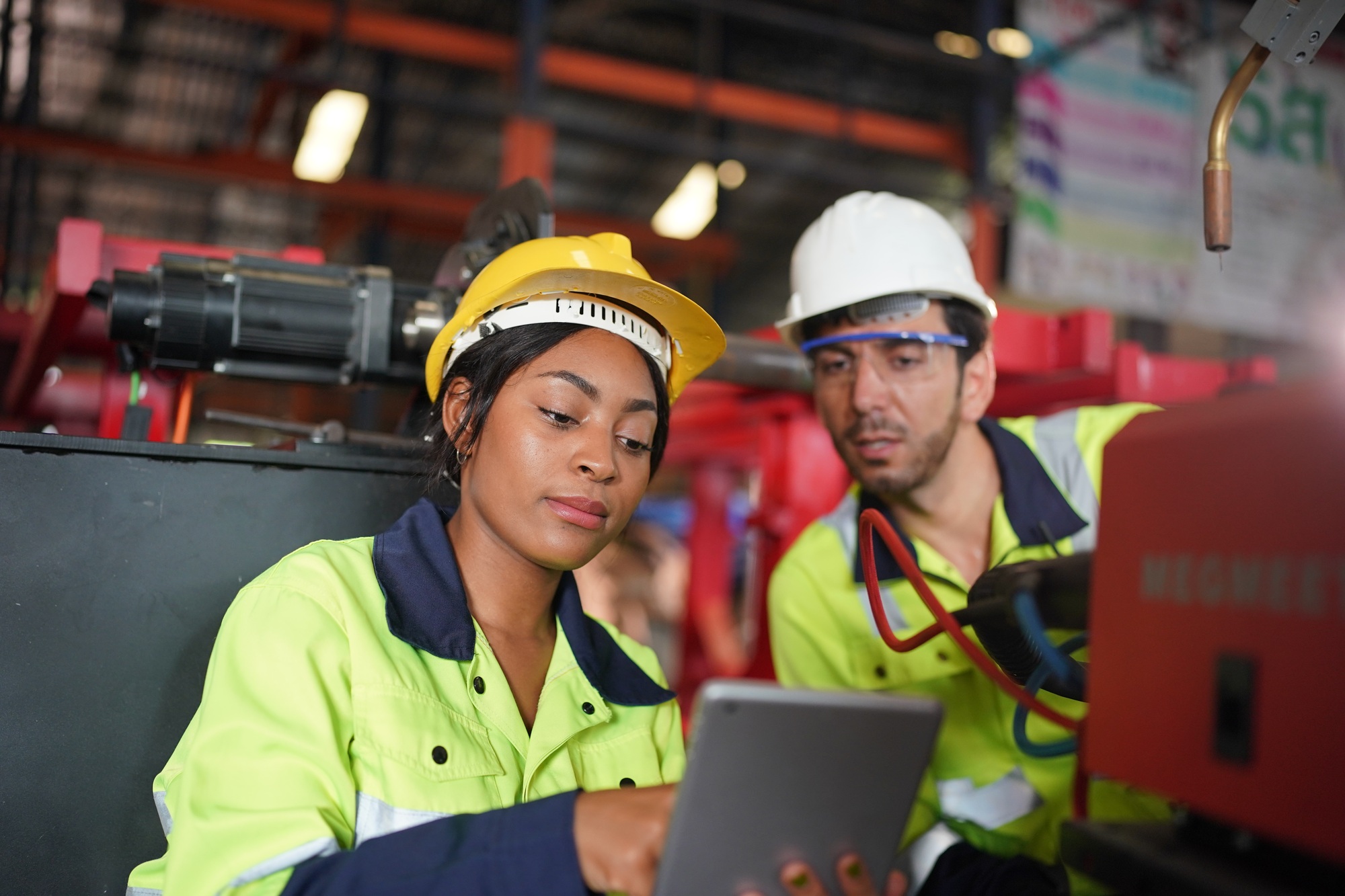Robotics engineer working on maintenance of robotic arm in factory warehouse. Business technology.